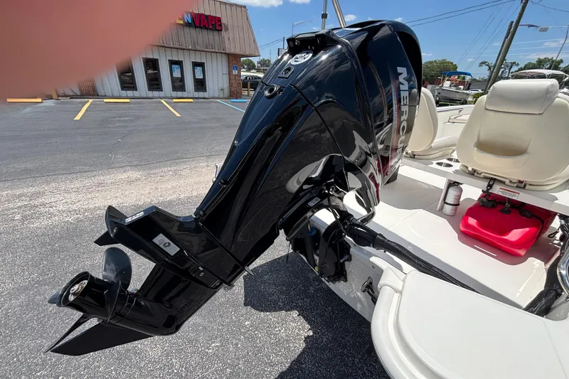 Slide: The Image of 2025 Boston Whaler 130 Super Sport with Mercury outboard motor, parked in a lot. - 16