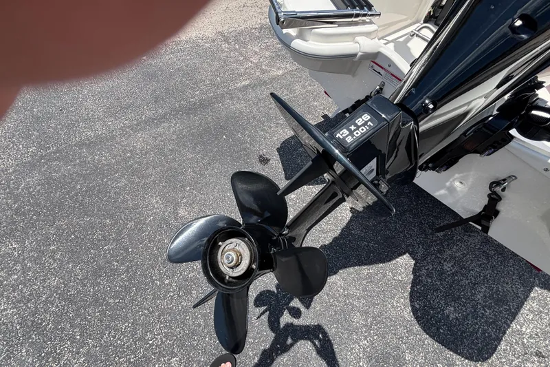 Slide: The Image of Propeller of 2025 Boston Whaler 130 Super Sport boat on asphalt surface. - 19