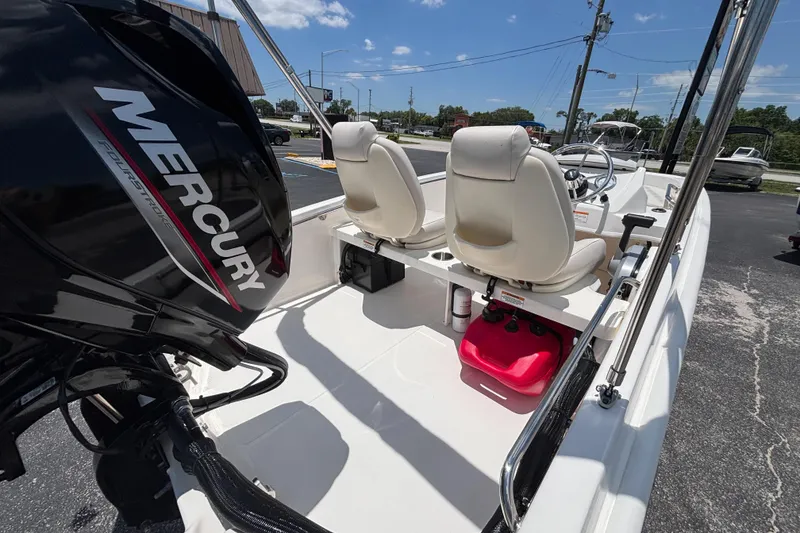 Slide: The Image of 2025 Boston Whaler 130 Super Sport boat interior with Mercury engine, featuring dual seats. - 23