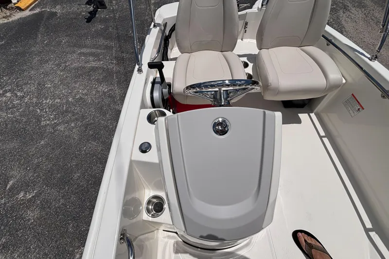 Slide: The Image of 2025 Boston Whaler 130 Super Sport interior with steering wheel and seating. - 24
