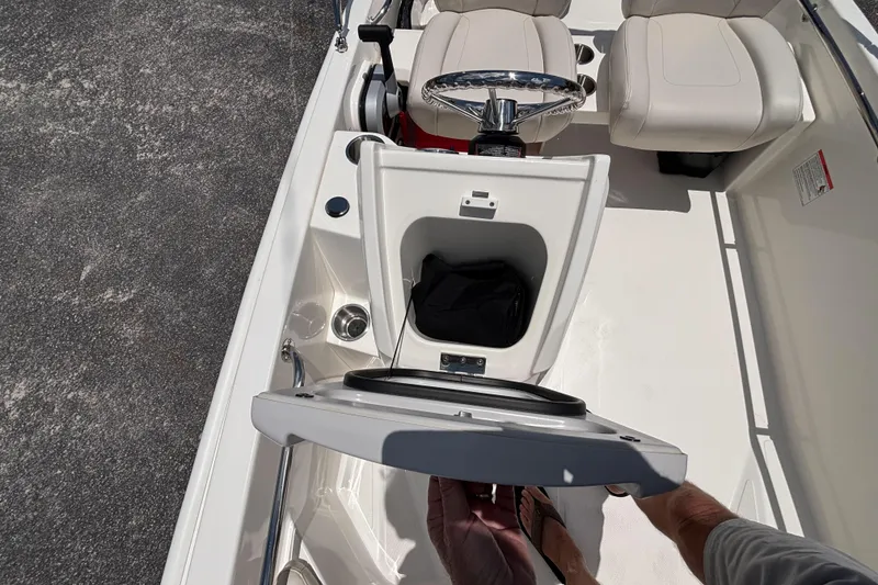 Slide: The Image of 2025 Boston Whaler 130 Super Sport interior with open storage compartment and seating. - 25