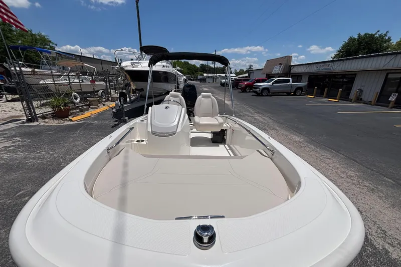 Slide: The Image of 2025 Boston Whaler 130 Super Sport boat displayed outdoors on a sunny day. - 33