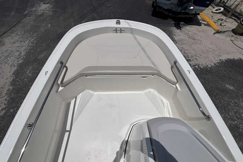 Slide: The Image of 2025 Boston Whaler 130 Super Sport boat interior with sleek design and stainless steel rails. - 36