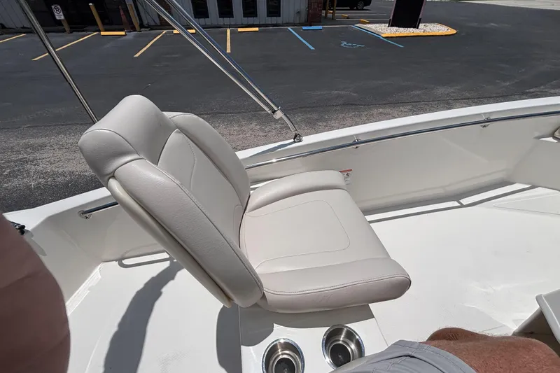 Slide: The Image of 2025 Boston Whaler 130 Super Sport boat interior with comfortable seating and cup holders. - 38