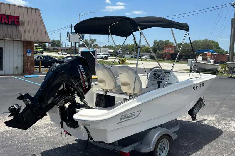 Slide: The Image of 2025 Boston Whaler 130 Super Sport boat with Mercury engine on trailer. - 5