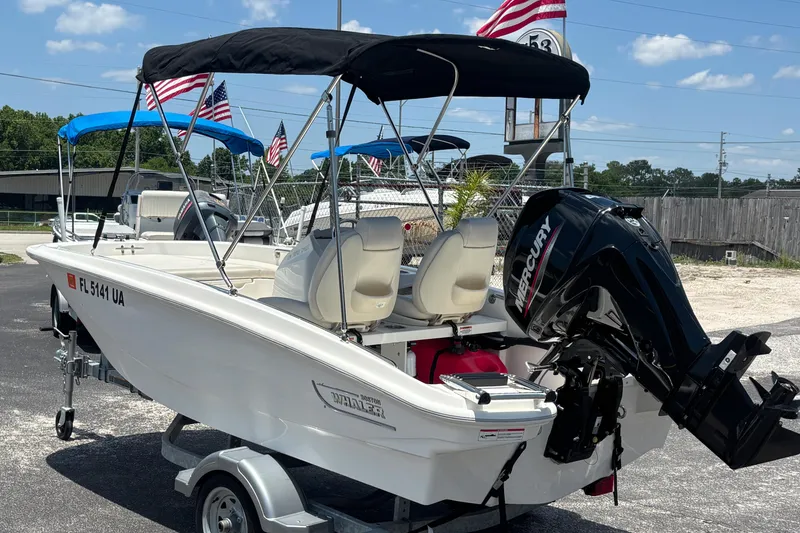 Slide: The Image of 2025 Boston Whaler 130 Super Sport boat with Mercury engine on trailer. - 8
