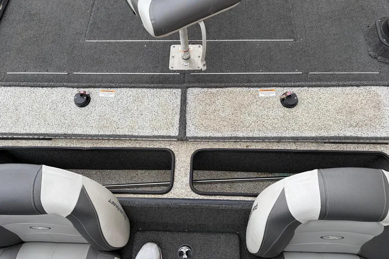 Slide: The Image of 2018 Polarcraft TX 195 boat interior with gray seating and storage compartments. - 11