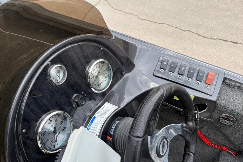 Slide: The Image of 2018 Polarcraft TX 195 boat dashboard with steering wheel and gauges. - 12