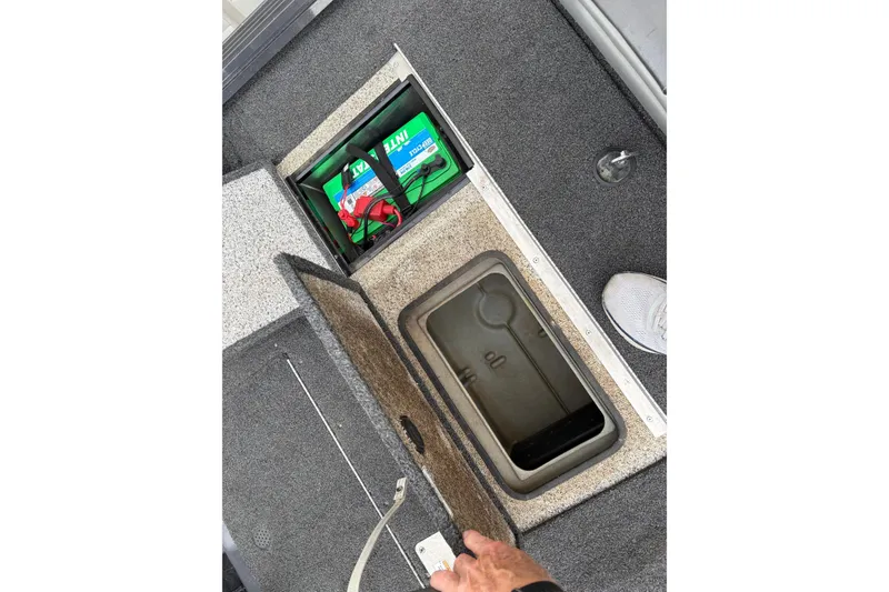Slide: The Image of 2018 Polarcraft TX 195 boat storage compartments with battery and accessories. - 14