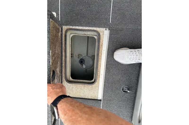 Slide: The Image of 2018 Polarcraft TX 195 boat storage compartment with open lid, showing interior details. - 16