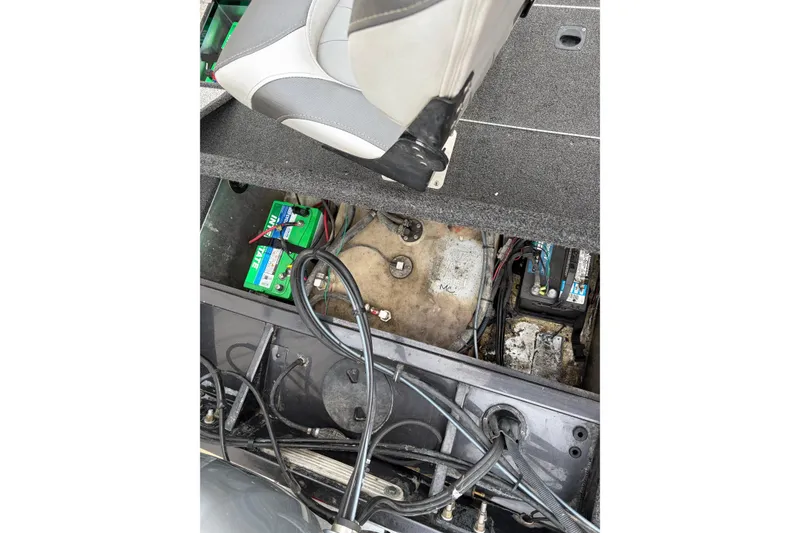 Slide: The Image of Interior view of a 2018 Polarcraft TX 195 boat showing battery compartment and wiring. - 20