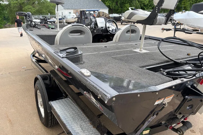 Slide: The Image of 2018 Polarcraft TX 195 fishing boat on trailer, featuring spacious deck and seating. - 24