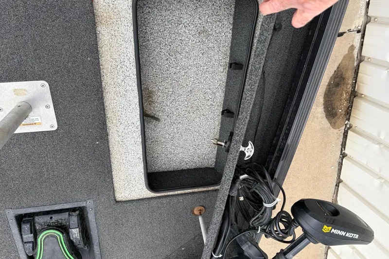 Slide: The Image of Open storage compartment on a 2018 Polarcraft TX 195 boat with Minn Kota trolling motor. - 30