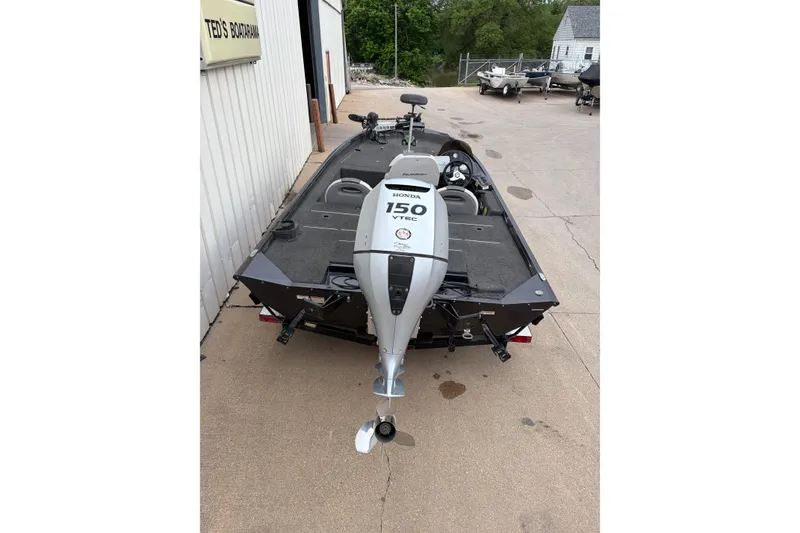 Slide: The Image of 2018 Polarcraft TX 195 boat with Honda 150 VTEC outboard motor, parked outdoors. - 4