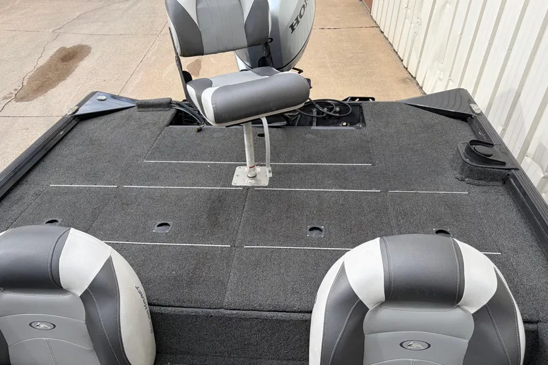 Slide: The Image of 2018 Polarcraft TX 195 boat interior with gray seating and carpeted deck. - 6