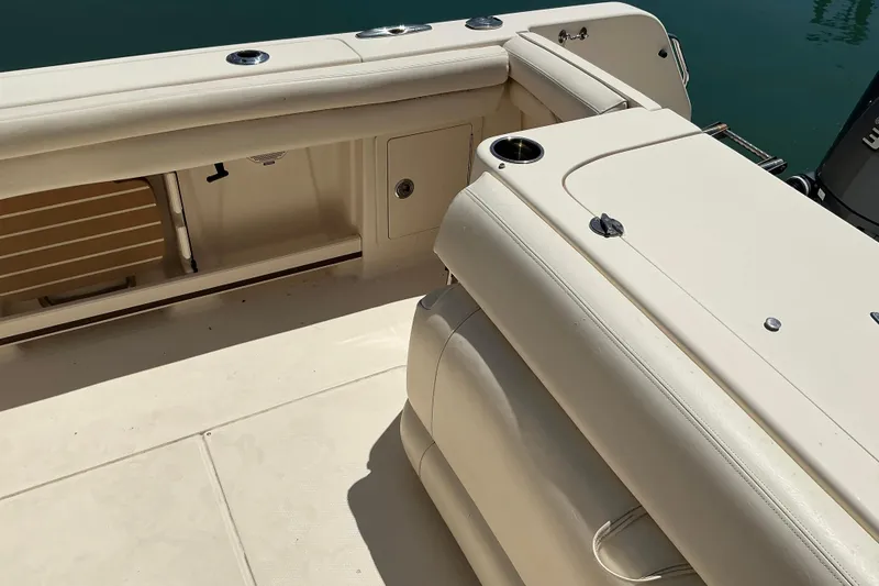 Slide: The Image of 2018 Grady-White Freedom 285 boat interior with beige seating and storage compartments. - 12