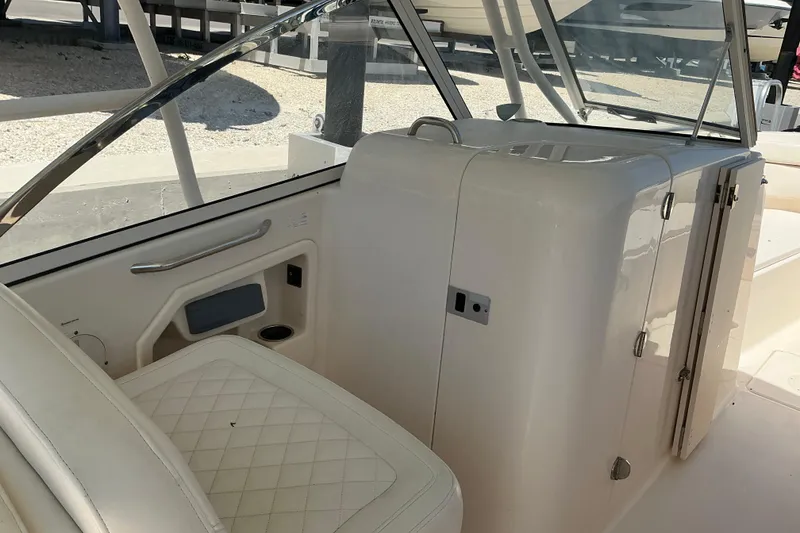 Slide: The Image of 2018 Grady-White Freedom 285 boat interior with white seating and storage compartment. - 14
