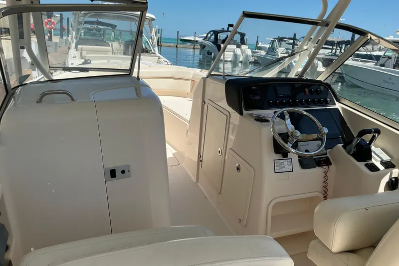 Slide: The Image of 2018 Grady-White Freedom 285 boat interior with steering console, docked at marina. - 19