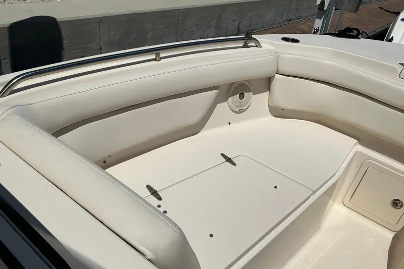 Slide: The Image of 2018 Grady-White Freedom 285 boat interior with cushioned seating and speaker. - 2
