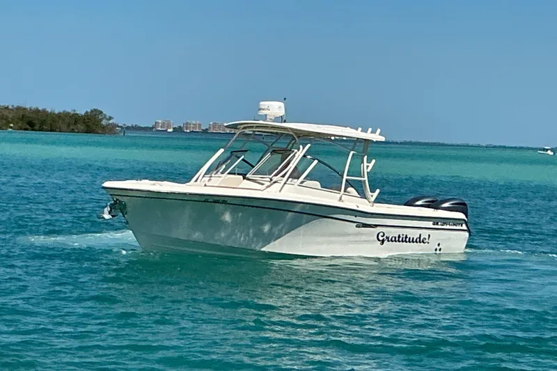 Slide: The Image of 2018 Grady-White Freedom 285 boat cruising on turquoise waters. - 26