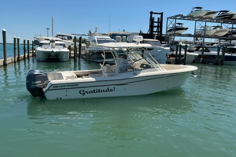 Slide: The Image of 2018 Grady-White Freedom 285 boat named "Gratitude" docked in a marina. - 29