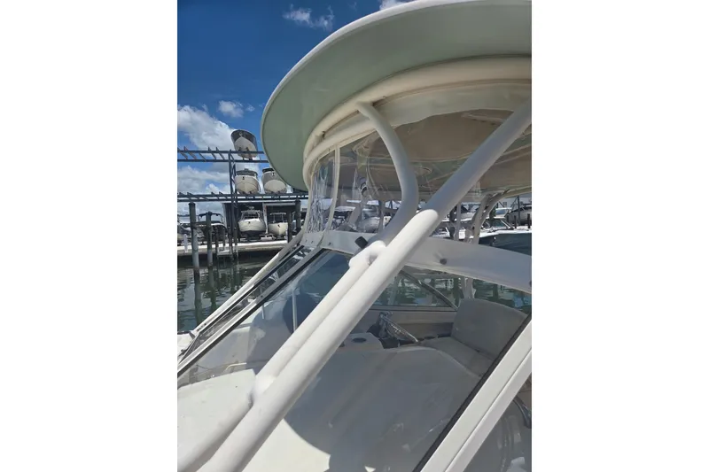 Slide: The Image of 2018 Grady-White Freedom 285 boat docked under clear blue sky. - 6