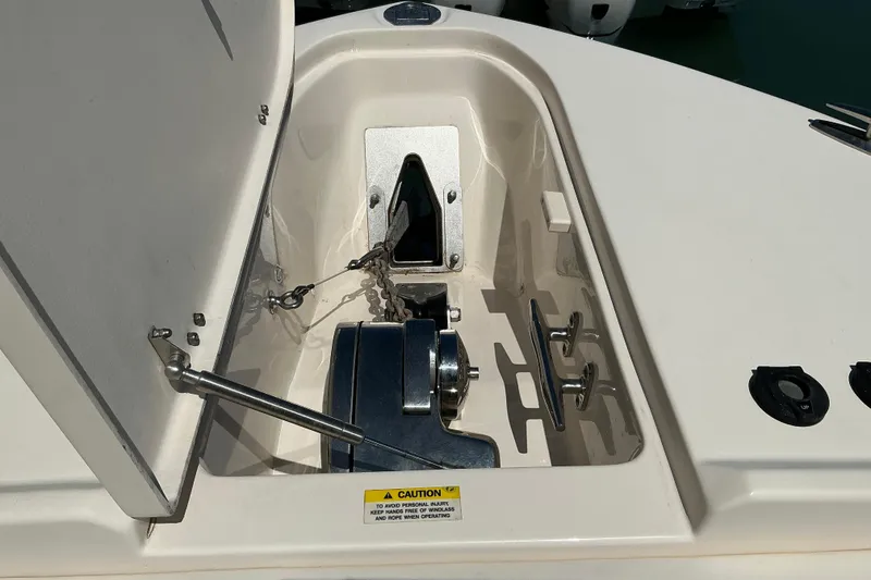 Slide: The Image of Anchor compartment of 2018 Grady-White Freedom 285 boat, featuring chain and cleats. - 4