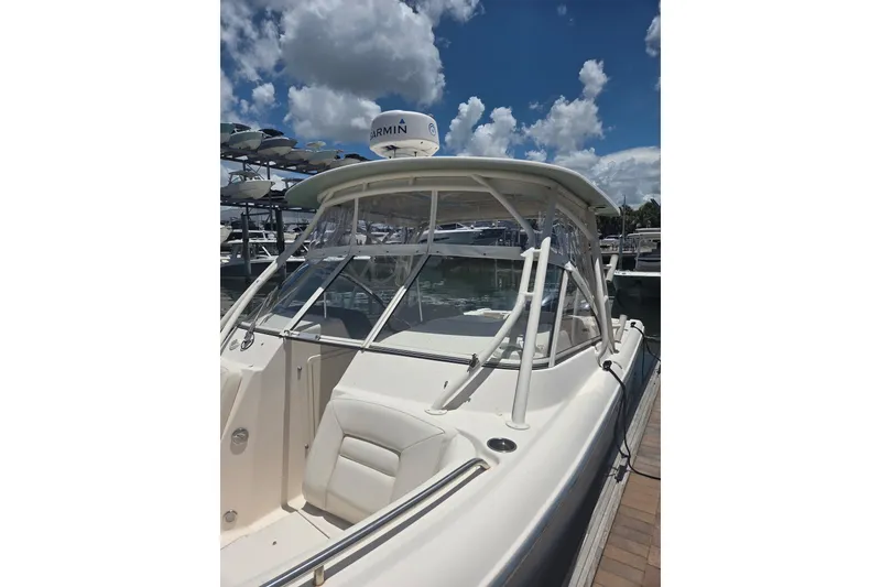 Slide: The Image of 2018 Grady-White Freedom 285 boat docked under a partly cloudy sky. - 4