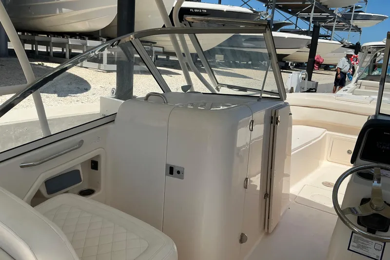 Slide: The Image of 2018 Grady-White Freedom 285 boat interior with seating and steering wheel. - 8