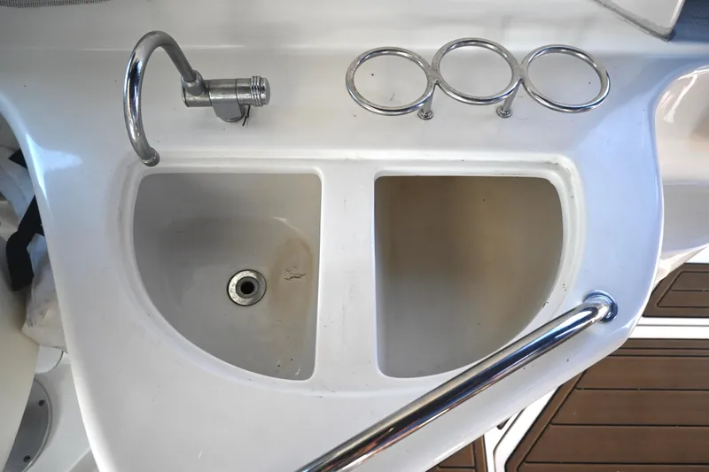 Slide: The Image of 2005 Sea Ray Sundancer 280 boat sink with faucet and cup holders. - 14