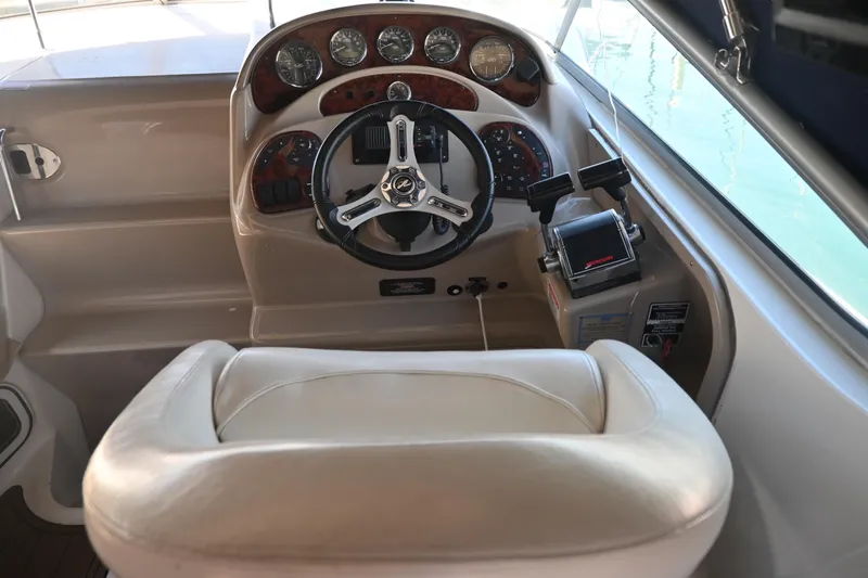 Slide: The Image of 2005 Sea Ray Sundancer 280 helm with steering wheel and control panel. - 16