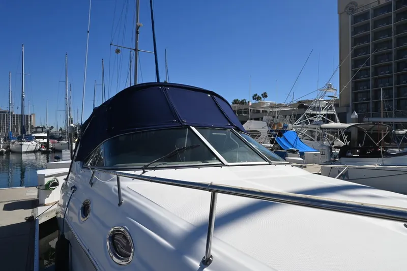 Slide: The Image of 2005 Sea Ray Sundancer 280 docked at marina, clear blue sky background. - 3