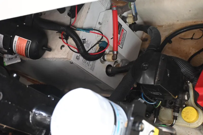 Slide: The Image of Engine compartment of a 2005 Sea Ray Sundancer 280, showing various mechanical components. - 34