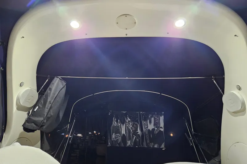 Slide: The Image of 2005 Sea Ray Sundancer 280 interior with illuminated canopy and speakers at night. - 40