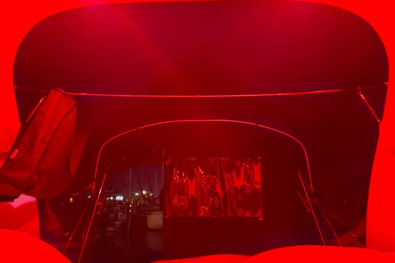 Slide: The Image of Interior of 2005 Sea Ray Sundancer 280 under red lighting at night. - 43