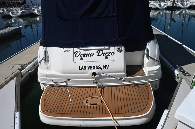 Slide: The Image of 2005 Sea Ray Sundancer 280 boat named "Ocean Daze" docked in a marina. - 8