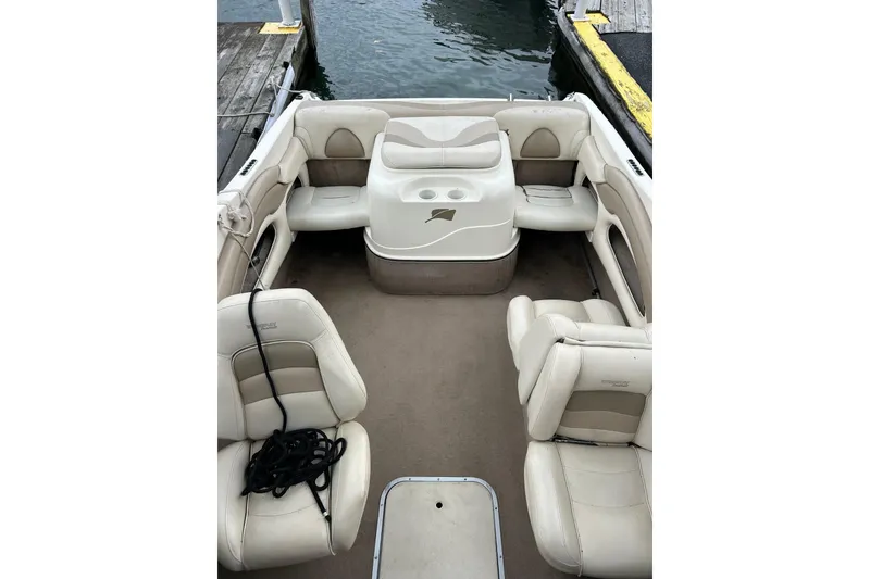 Slide: The Image of 2001 Stingray 200 LS/LX boat interior with beige seating and open deck layout. - 12