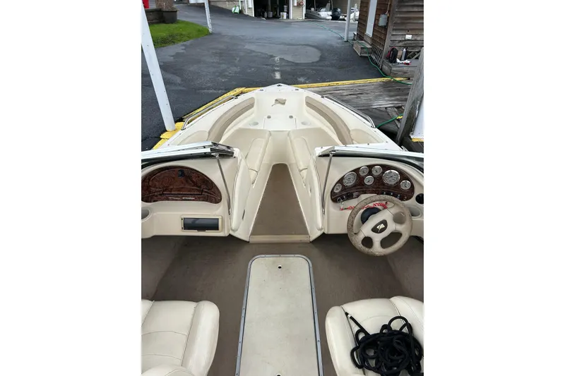 Slide: The Image of 2001 Stingray 200 LS/LX boat interior with beige seating and dashboard controls. - 15