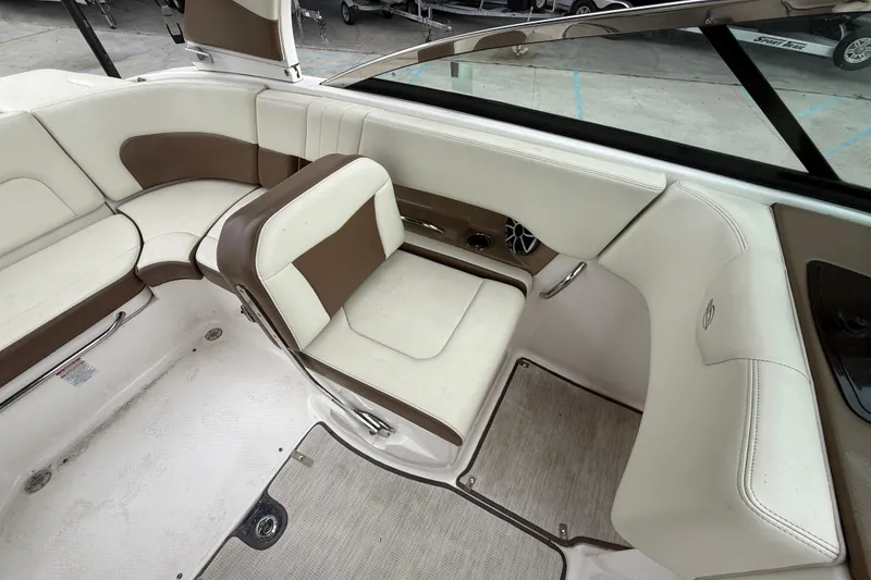 Slide: The Image of 2018 Chaparral 227 SSX Surf boat interior with beige and brown seating. - 10