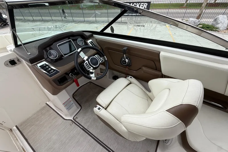 Slide: The Image of 2018 Chaparral 227 SSX Surf boat cockpit with steering wheel and control panel. - 11