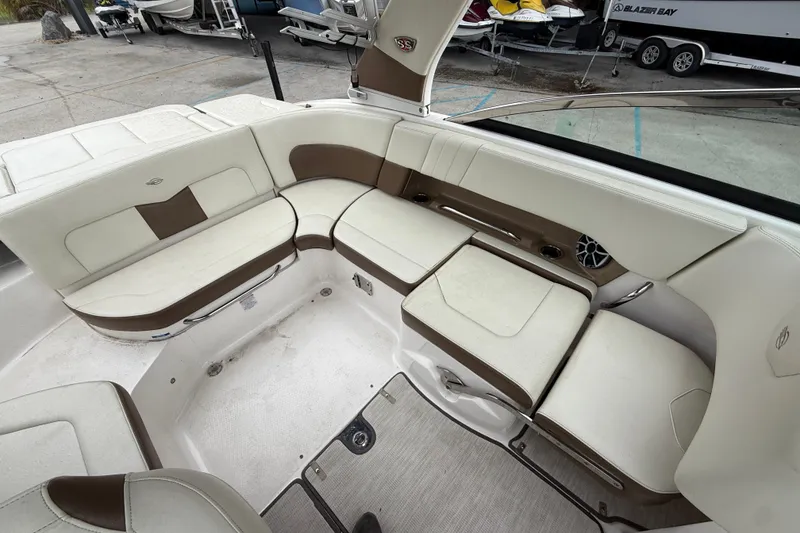 Slide: The Image of 2018 Chaparral 227 SSX Surf boat interior with white and brown seating. - 13