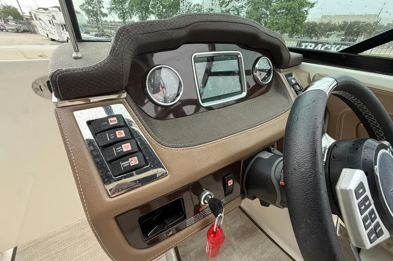 Slide: The Image of Dashboard of 2018 Chaparral 227 SSX Surf boat with steering wheel and control panel. - 15