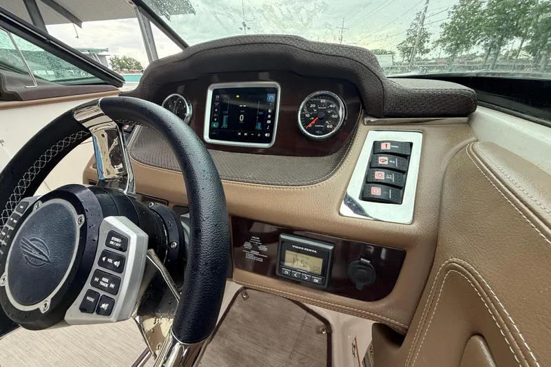 Slide: The Image of 2018 Chaparral 227 SSX Surf dashboard with steering wheel, controls, and digital display. - 16