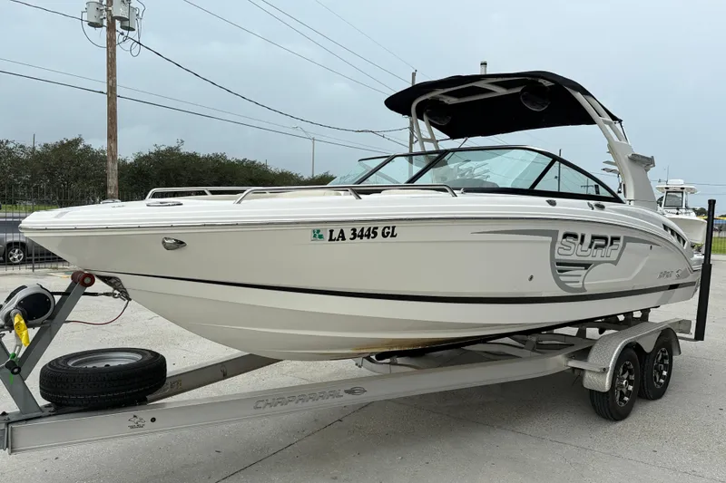 Slide: The Image of 2018 Chaparral 227 SSX Surf boat on trailer, parked outdoors. - 3