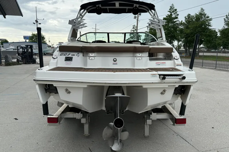 Slide: The Image of 2018 Chaparral 227 SSX Surf boat, rear view, on trailer, in outdoor setting. - 5
