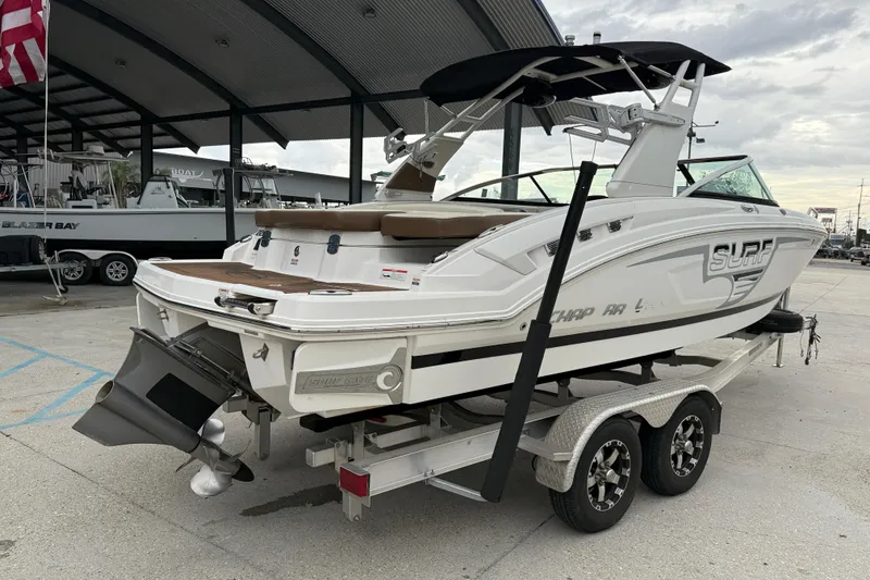 Slide: The Image of 2018 Chaparral 227 SSX Surf boat on trailer at marina. - 6