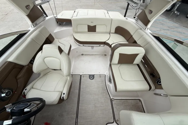 Slide: The Image of 2018 Chaparral 227 SSX Surf boat interior with white and brown seating. - 9