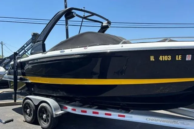 Slide: The Image of 2023 Chaparral 267 SSX boat on trailer, black with yellow stripe. - 1