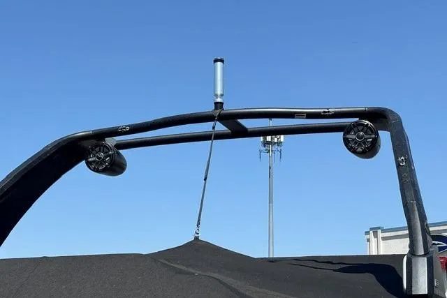 Slide: The Image of 2023 Chaparral 267 SSX boat tower with speakers against clear blue sky. - 28