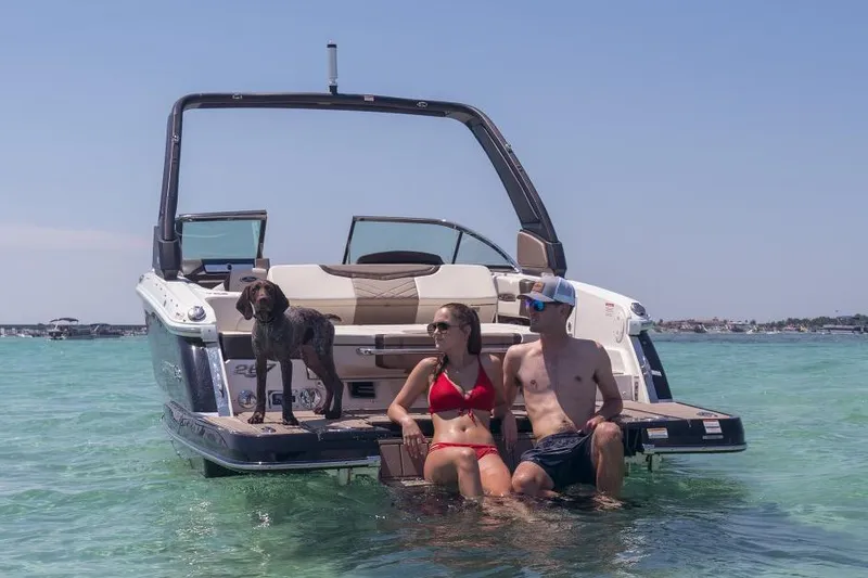 Slide: The Image of Manufacturer Provided Image: 2023 Chaparral 267 SSX boat with couple and dog enjoying the water. - 7